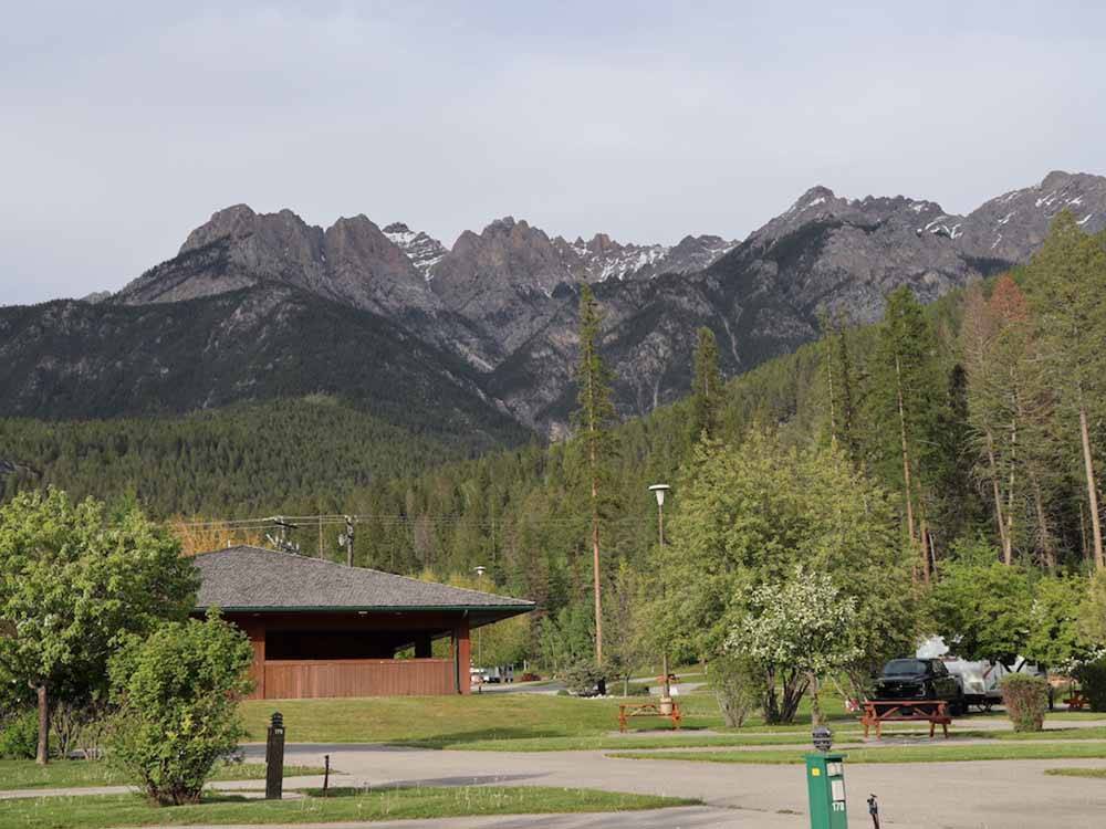 Looking at one of the buildings with mountains in the background at FAIRMONT HOT SPRINGS RESORT