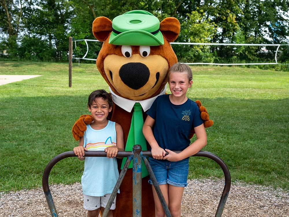 Two kids with Yogi the Bear at FRANKENMUTH YOGI BEAR'S JELLYSTONE PARK CAMP-RESORT