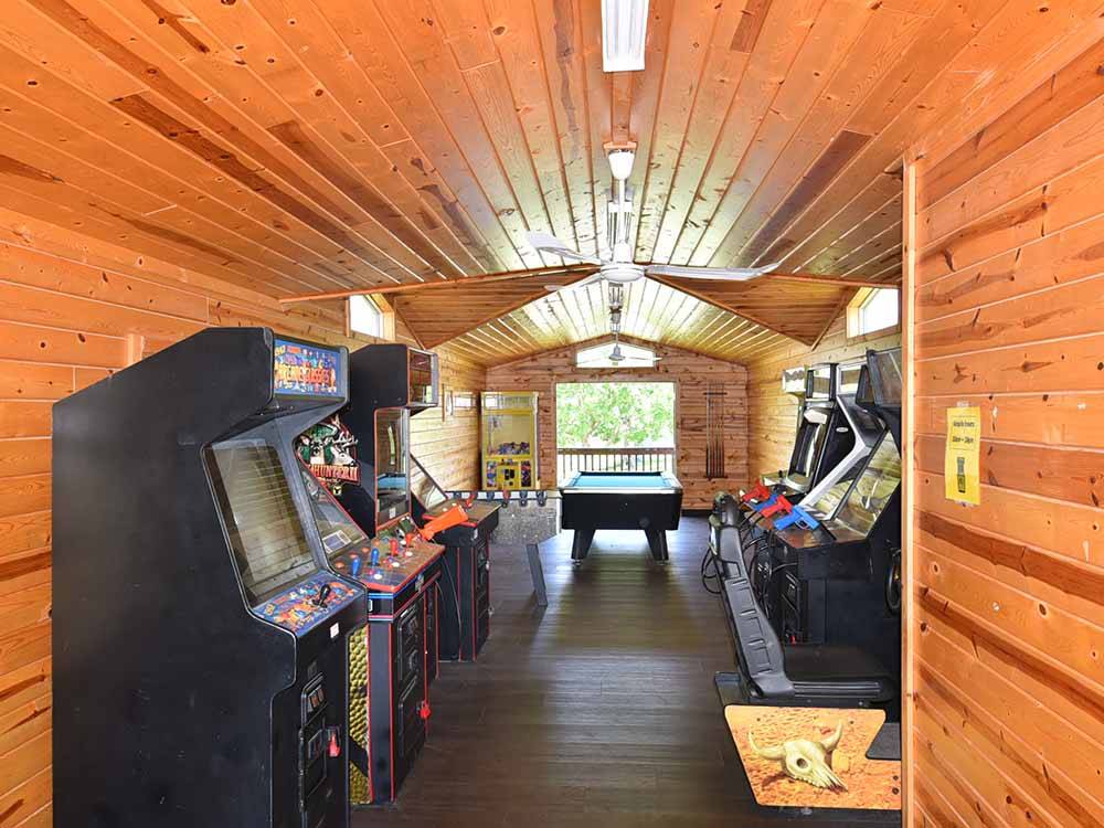 Inside of the arcade with a pool table at BISSELL'S HIDEAWAY RESORT