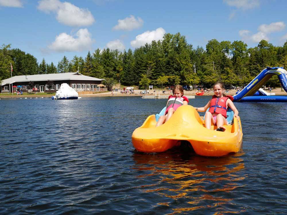 Kids paddle boating at FISHERMAN'S COVE TENT & TRAILER PARK