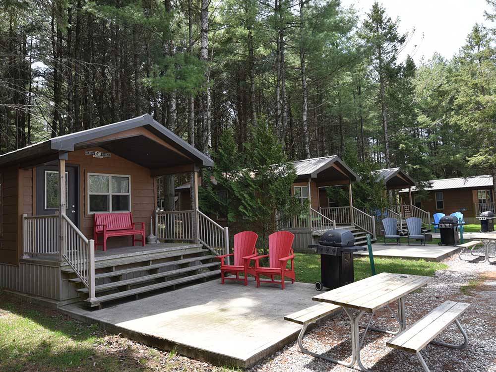 A row of rental cabins with decks at FISHERMAN'S COVE TENT & TRAILER PARK