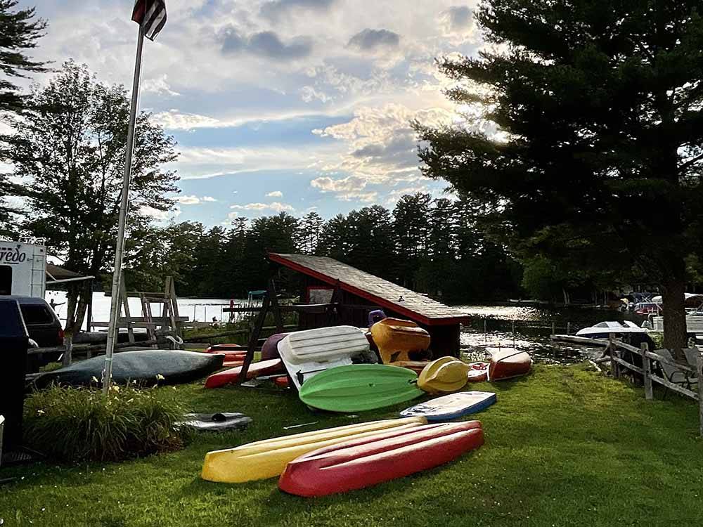 A stack of kayaks near the water at AUGUSTA-WEST LAKESIDE KAMPGROUND