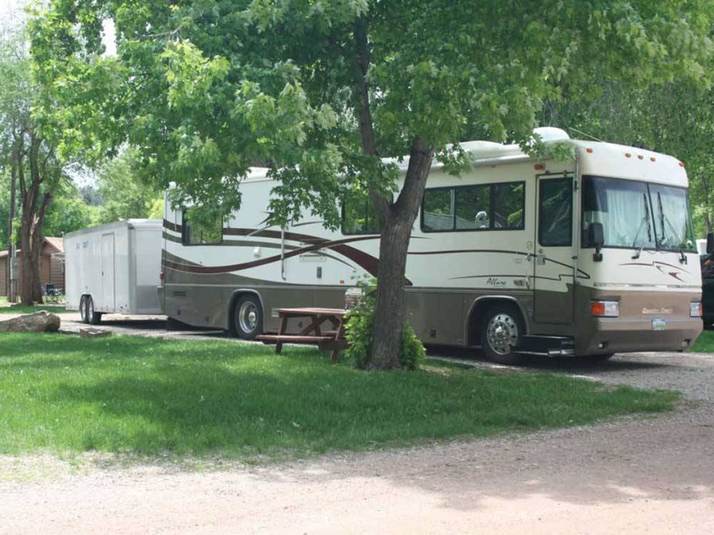 Class A Motorhome parked on-site at LAKE PARK CAMPGROUND & COTTAGES