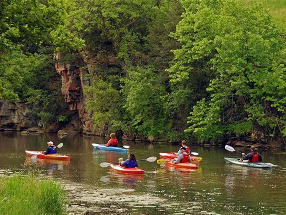 A group of people kayaking on water at LAKE PARK CAMPGROUND & COTTAGES