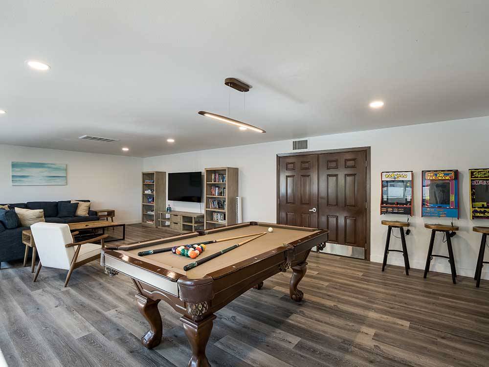 A recreation area with pool table and video games at OCEANSIDE RV RESORT