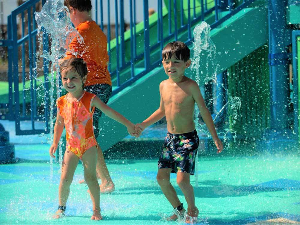 A couple of kids in the waterpark at LAKEWOOD CAMPING RESORT