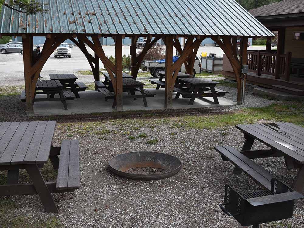 A fire pit with picnic tables at GOLDEN MUNICIPAL CAMPGROUND