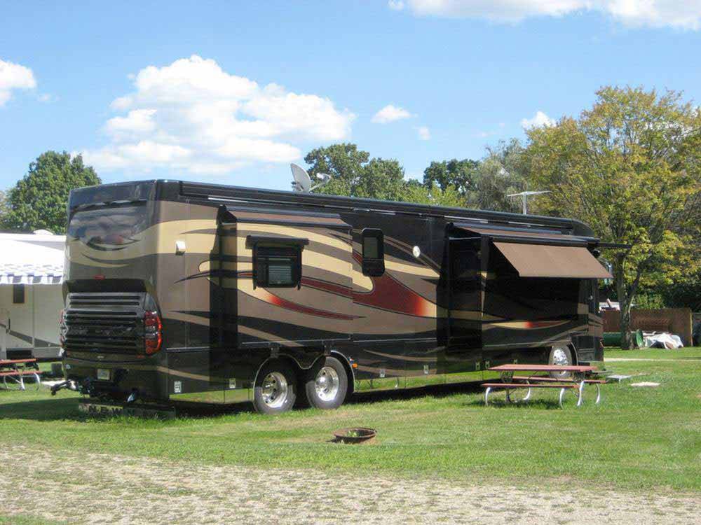 A motorhome in a grassy RV site at SPAULDING LAKE CAMPGROUND