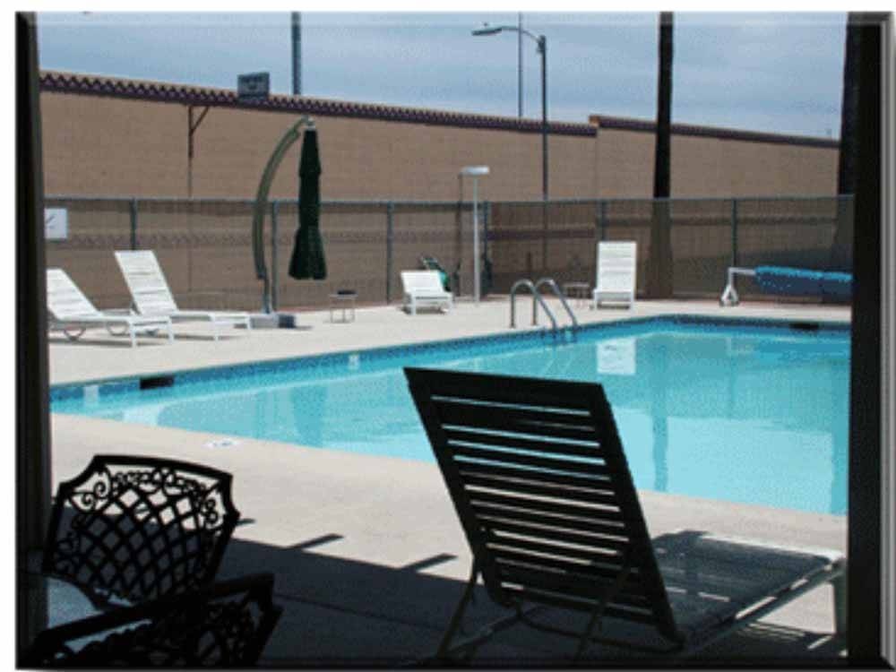 Pool area with lounge chair at PRINCE OF TUCSON RV PARK