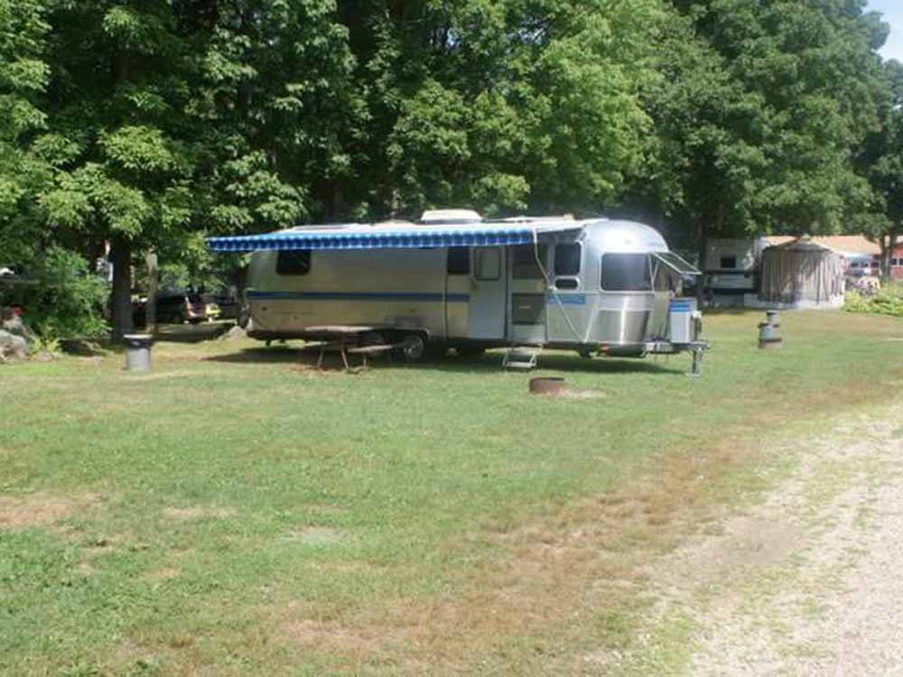 An Airstream in a grassy RV site at SALEM FARMS CAMPGROUND