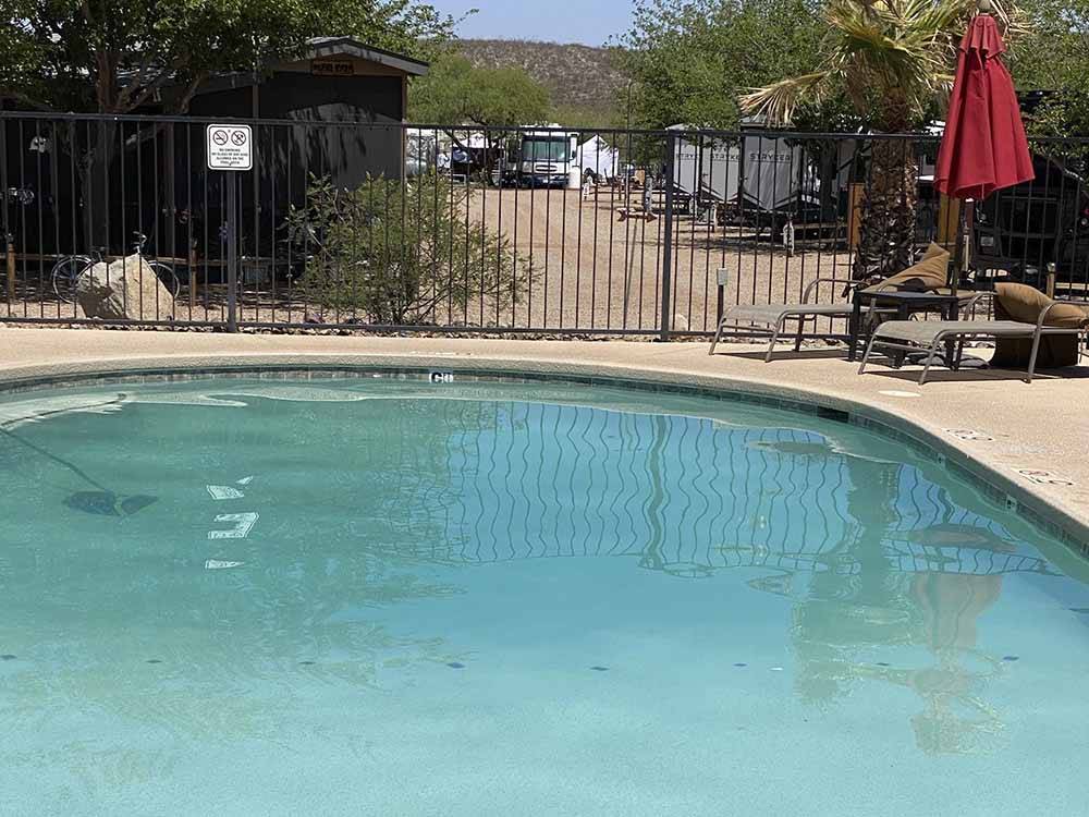 The fenced in swimming pool at TOMBSTONE RV PARK