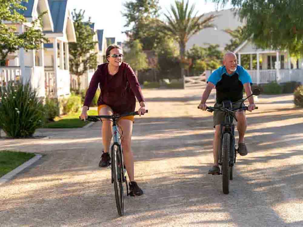 A couple riding bikes at FLYING FLAGS RV RESORT & CAMPGROUND