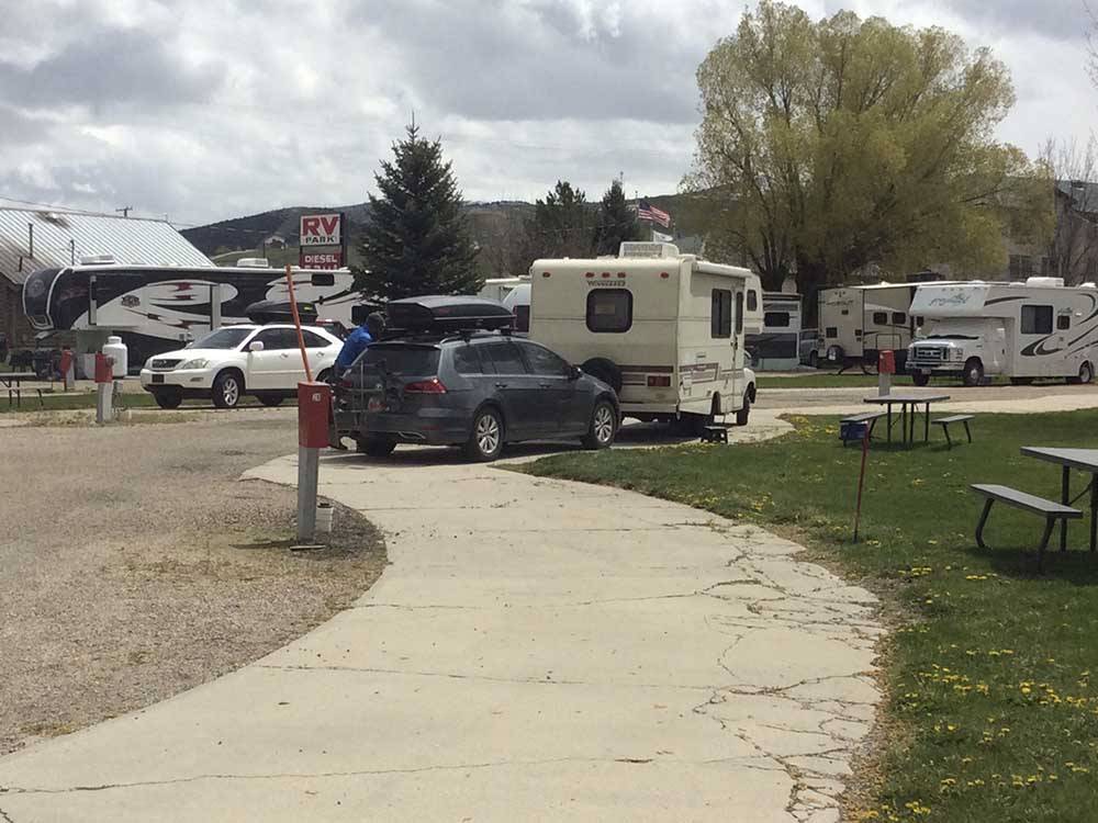A row of RV sites with picnic benches at HOLIDAY HILLS RV PARK
