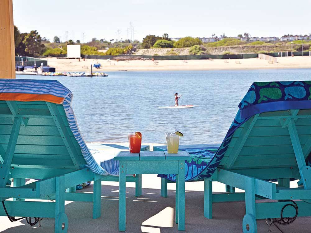 A couple of lounge chairs overlooking the water at NEWPORT DUNES WATERFRONT RESORT & MARINA