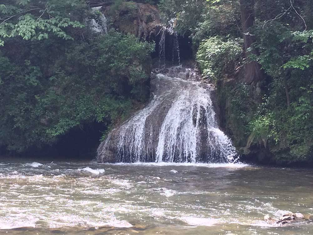 A waterfall with trees at SHENANDOAH VALLEY CAMPGROUND