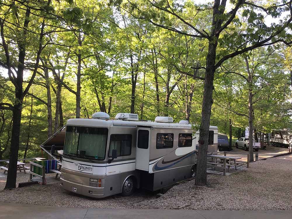 A motorhome in a rustic campsite at BLUE MOUNTAIN CAMPGROUND