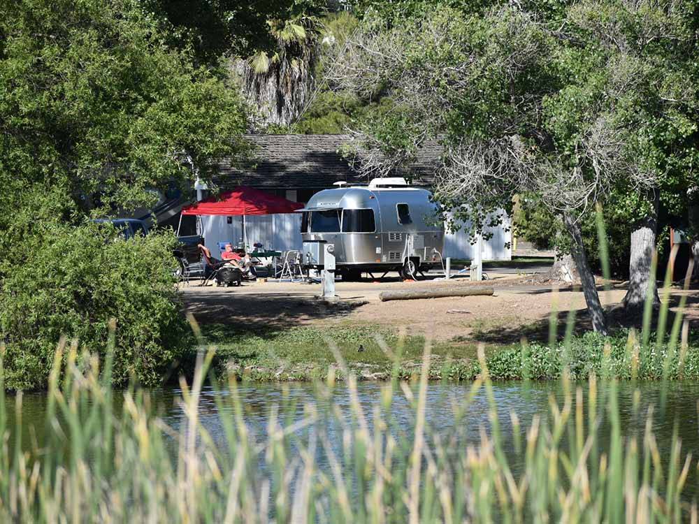 A trailer in an RV site along the water at SANTEE LAKES RECREATION PRESERVE