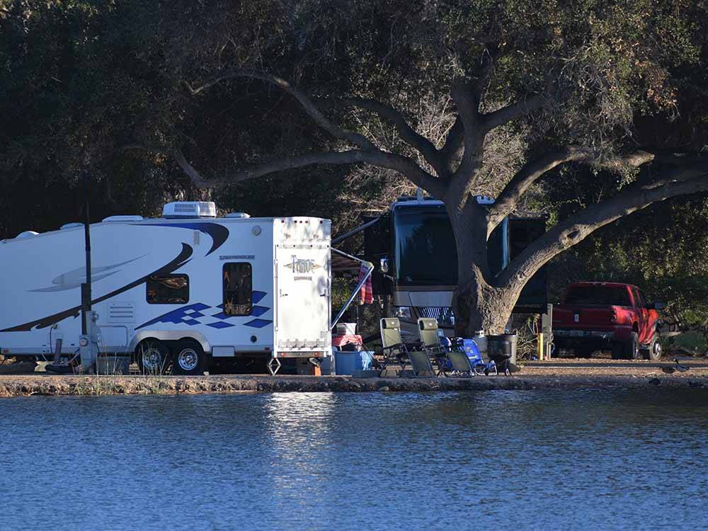 RV sites with trees along the water at SANTEE LAKES RECREATION PRESERVE