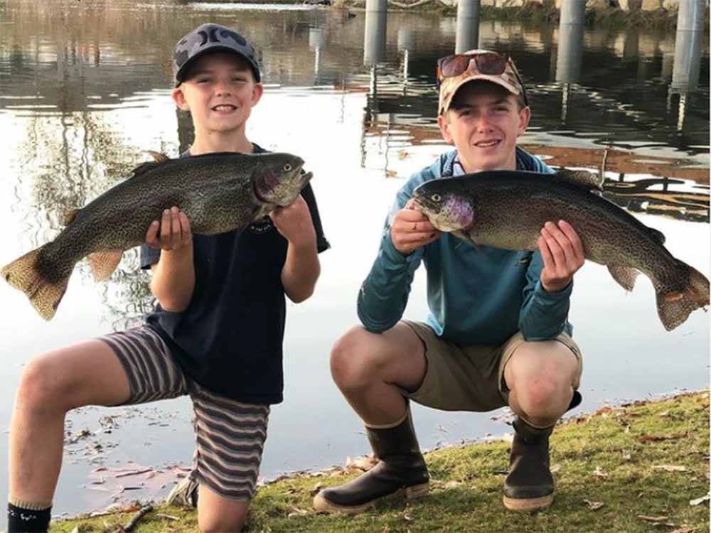 A couple of kids holding fish at SANTEE LAKES RECREATION PRESERVE