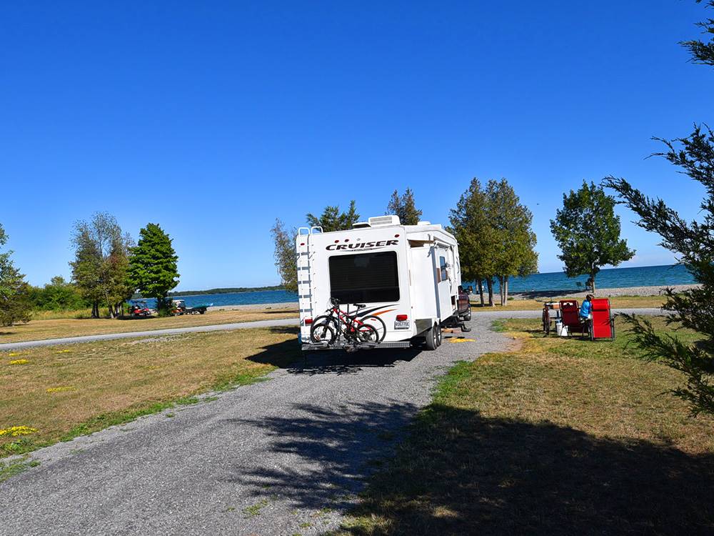 A fifth wheel parked in a pull through site at QUINTE'S ISLE CAMPARK