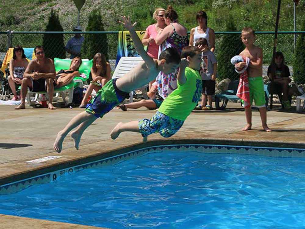 Two kids diving in pool at KING PHILLIPS CAMPGROUND