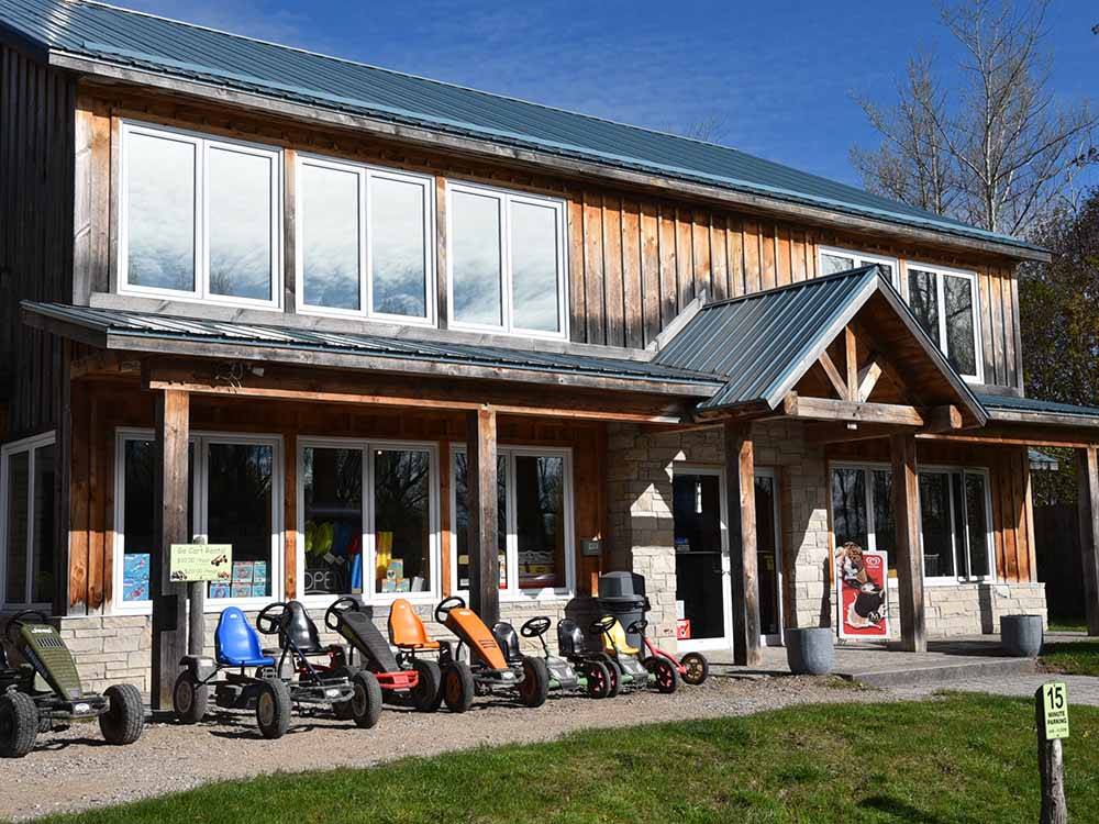 Pedal cars in front of a building at TOBERMORY VILLAGE CAMPGROUND & CABINS
