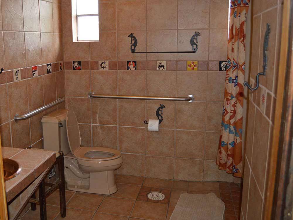 Bathroom with tiled walls and floor at MINGO RV PARK