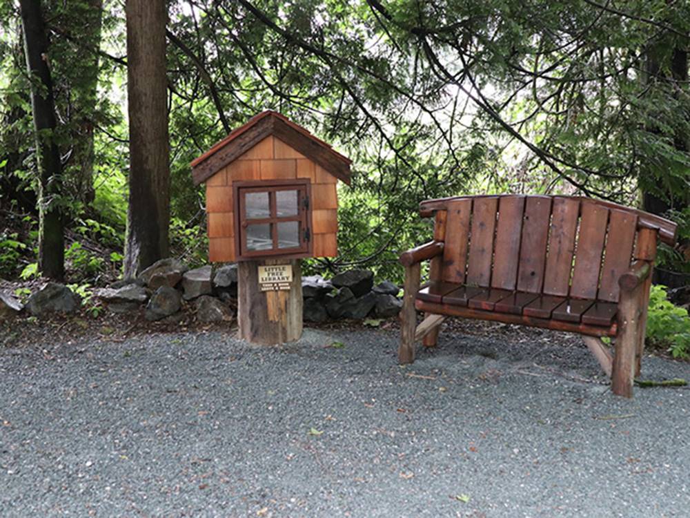 A small library and picnic bench at WILD ROSE CAMPGROUND & RV PARK