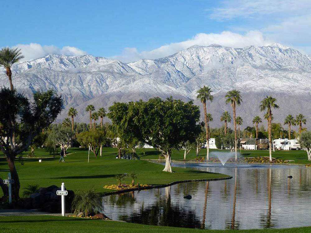 Man on golf course beside lake at OUTDOOR RESORT PALM SPRINGS