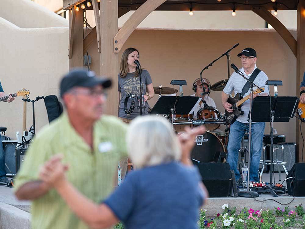 A couple dancing to a live band at SUNFLOWER RV RESORT