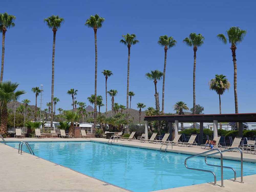 Swimming pool with outdoor seating at RINCON COUNTRY WEST RV RESORT