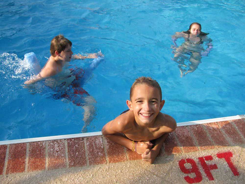Kids enjoying the swimming pool at ASHEVILLE BEAR CREEK RV PARK