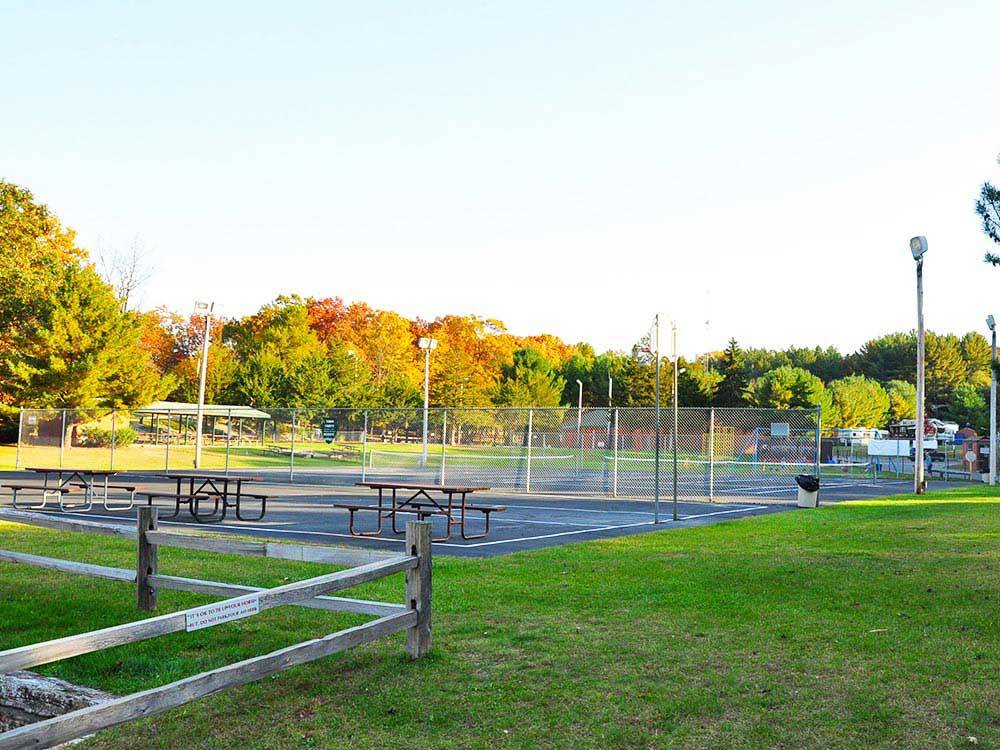 Picnic tables and tennis courts at ARROWHEAD RV CAMPGROUND
