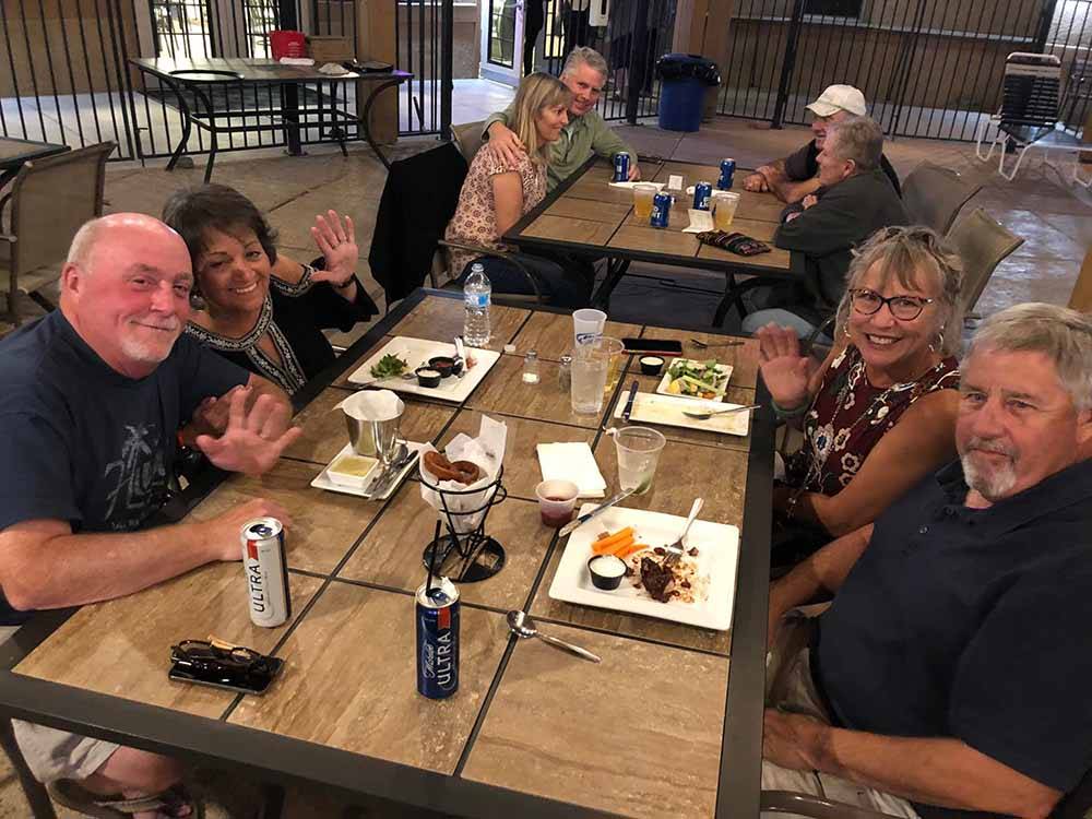 People sitting at a table and eating at RIO BEND RV & GOLF RESORT