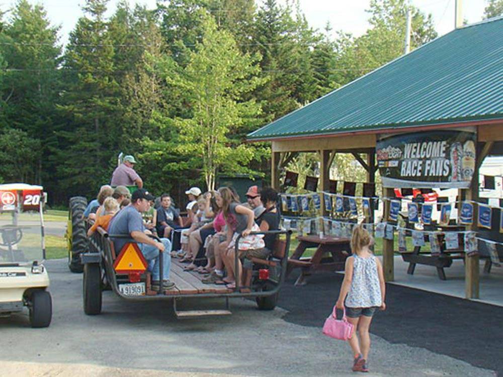 People enjoying a wagon ride at TIMBERLAND ACRES RV PARK