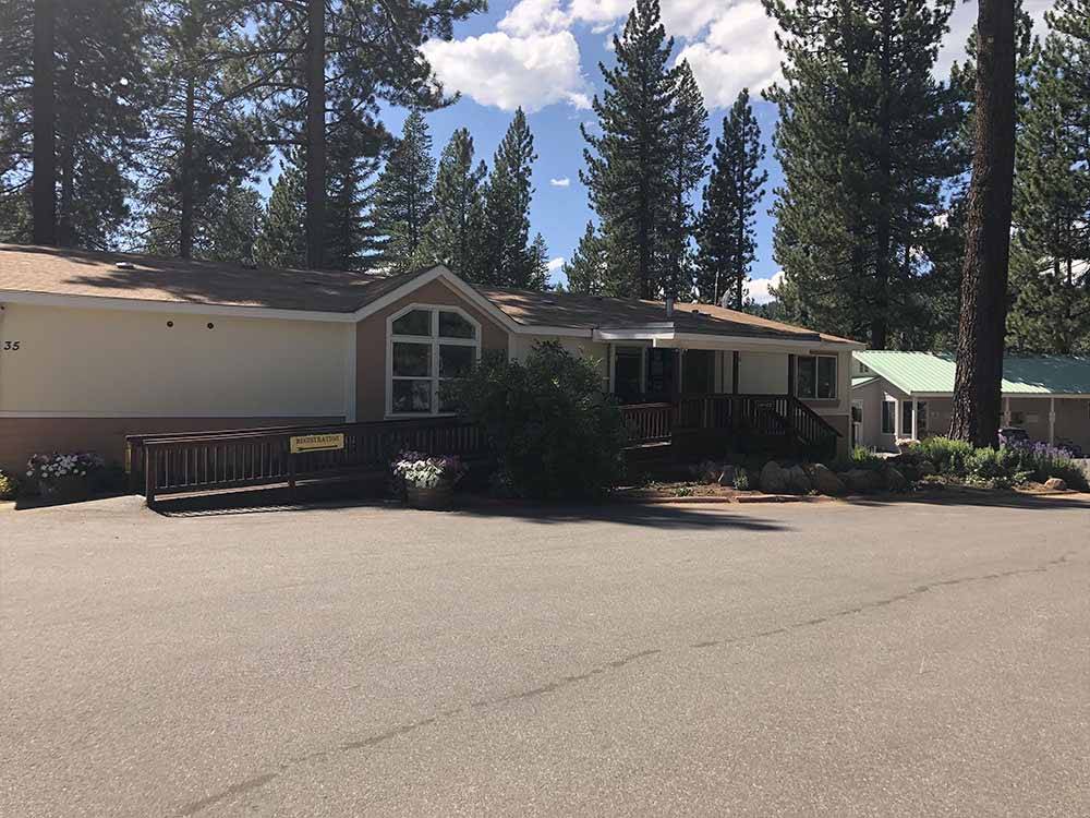 A large building with trees at COACHLAND RV RESORT / VILLAGE CAMP TRUCKEE