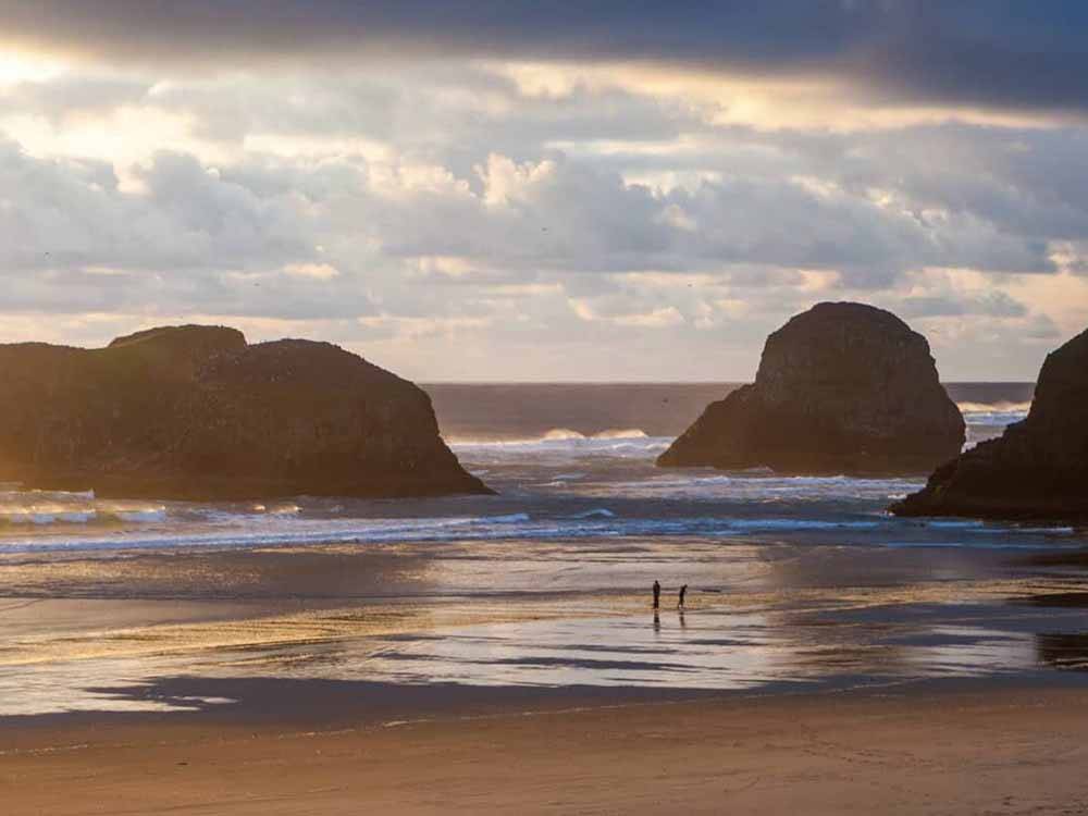 People walking along Cannon Beach at CANNON BEACH RV RESORT