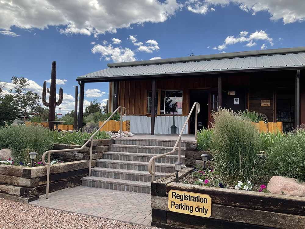 Brick stairs lead to office with cacti and desert plants at ROYAL VIEW RV PARK