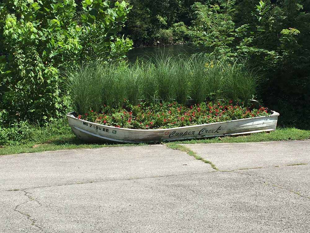 A boat used as a flower planter at COOPER CREEK RESORT & CAMPGROUND