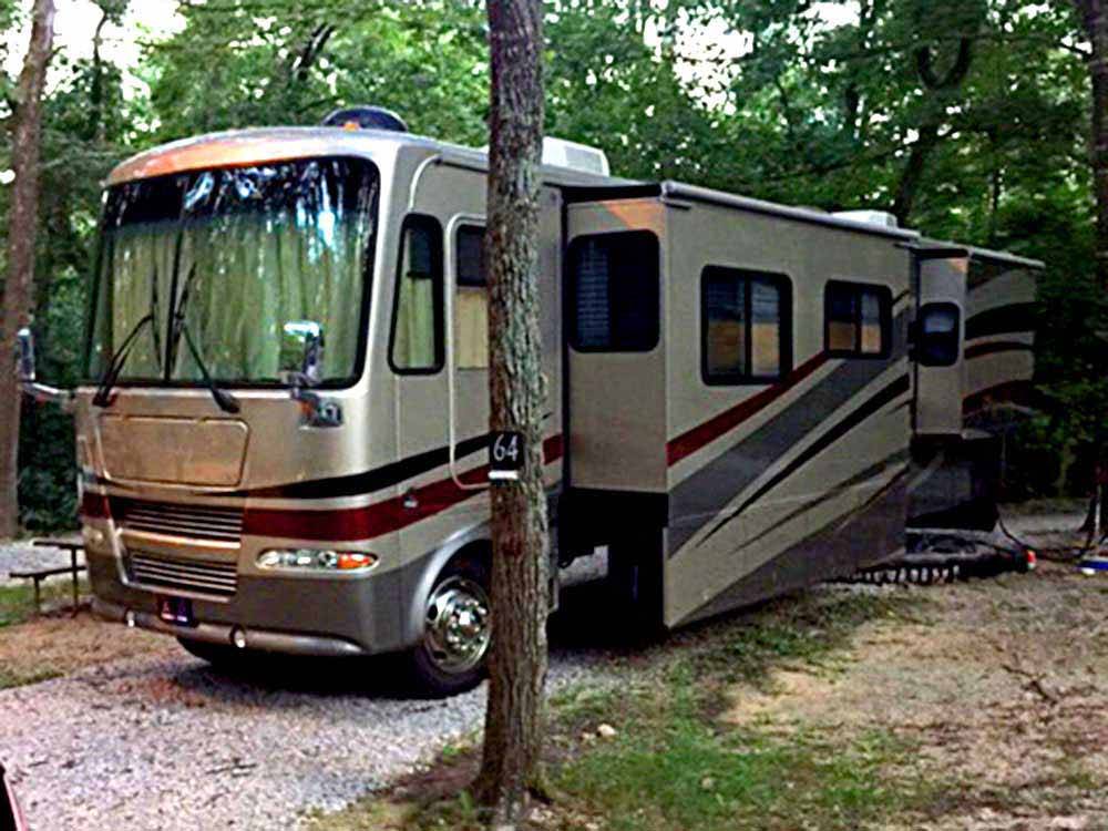 A motorhome in a gravel RV site at COOPER CREEK RESORT & CAMPGROUND