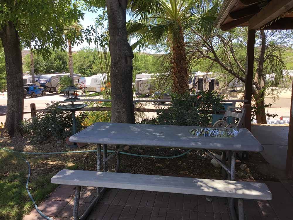 A picnic table by the main building at HORSPITALITY RV RESORT