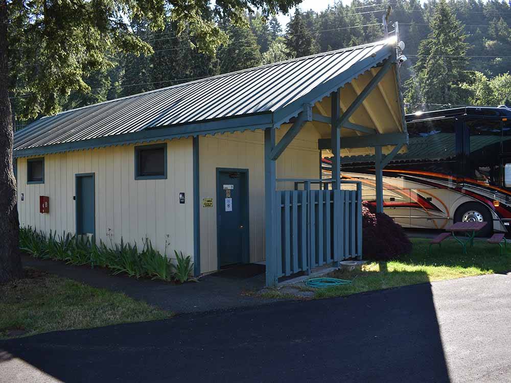 A motorhome next to the bathroom building at ISSAQUAH VILLAGE RV PARK