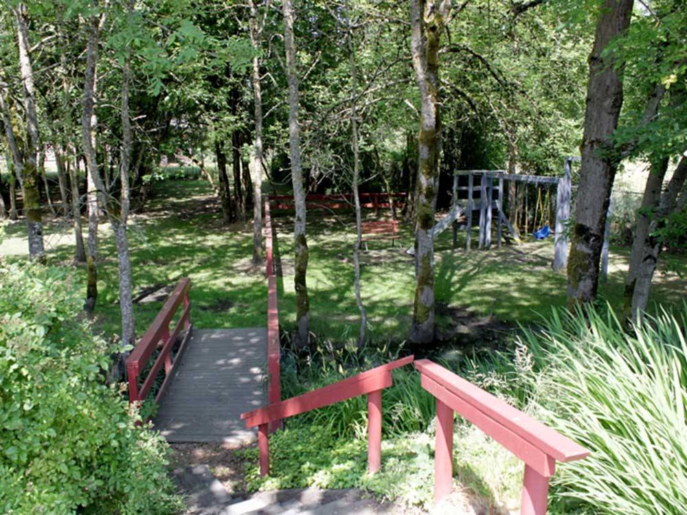 A wooden bridge going to the playground at PORTLAND WOODBURN RV PARK
