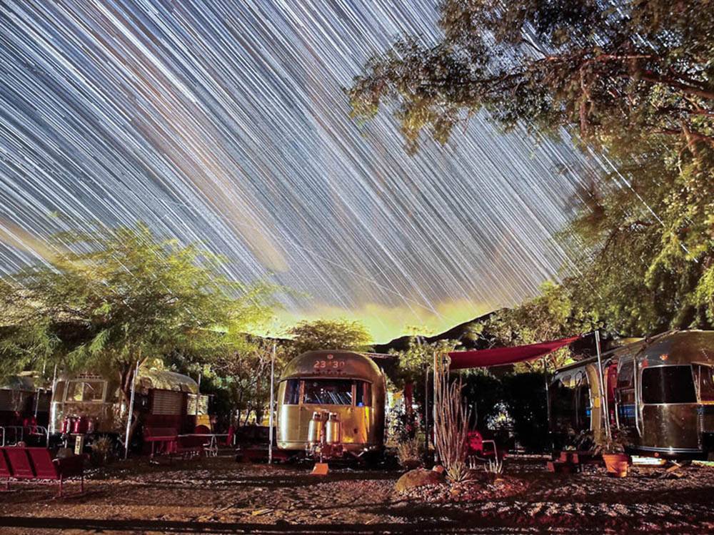 A long exposure shot of the campsites with stars over it at PALM CANYON HOTEL AND RV RESORT