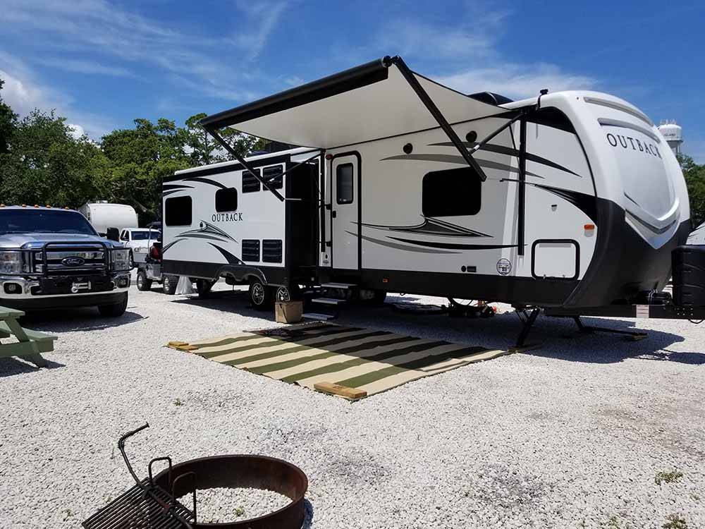 A travel trailer parked in one of the sites at RIVER'S END CAMPGROUND