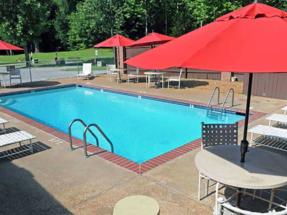 Swimming pool surrounded by outdoor seating at MEMPHIS GRACELAND RV PARK & CAMPGROUND