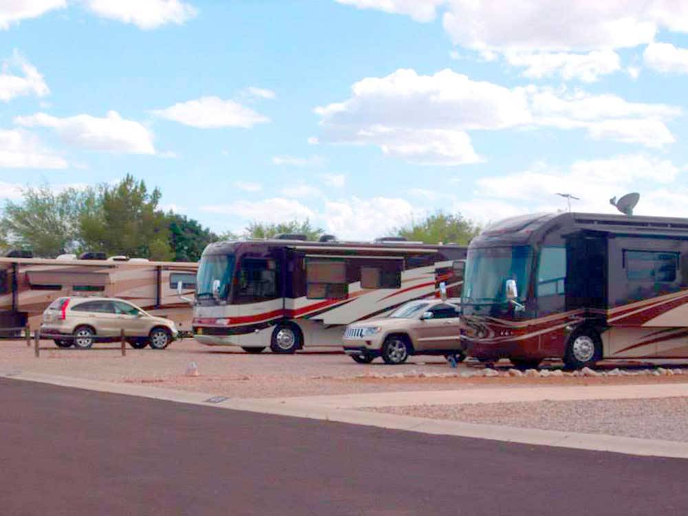 Row of big rig RVs on gravel sites at MISSION VIEW RV RESORT