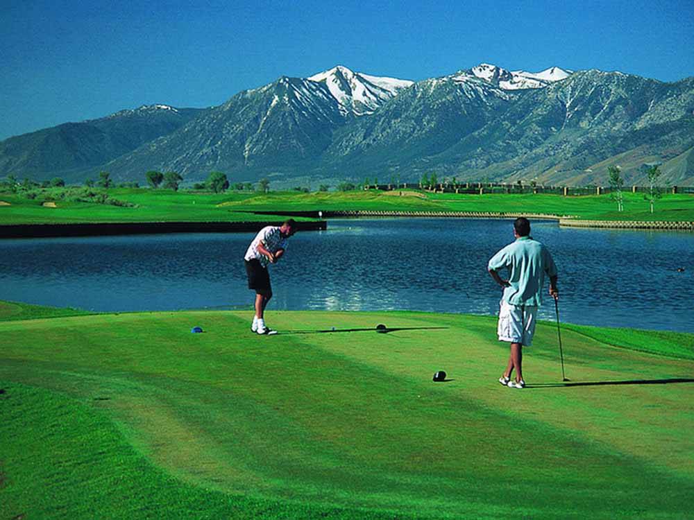 Two people playing golf at SILVER CITY RV RESORT