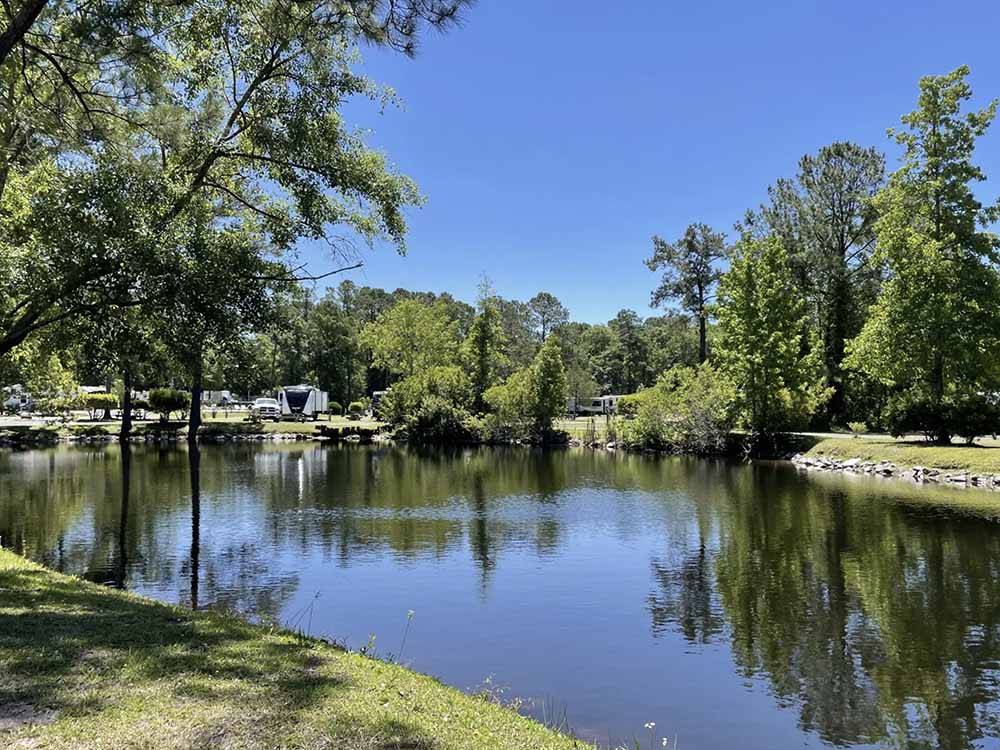 The lake with RV sites nearby at LAKE AIRE RV PARK & CAMPGROUND