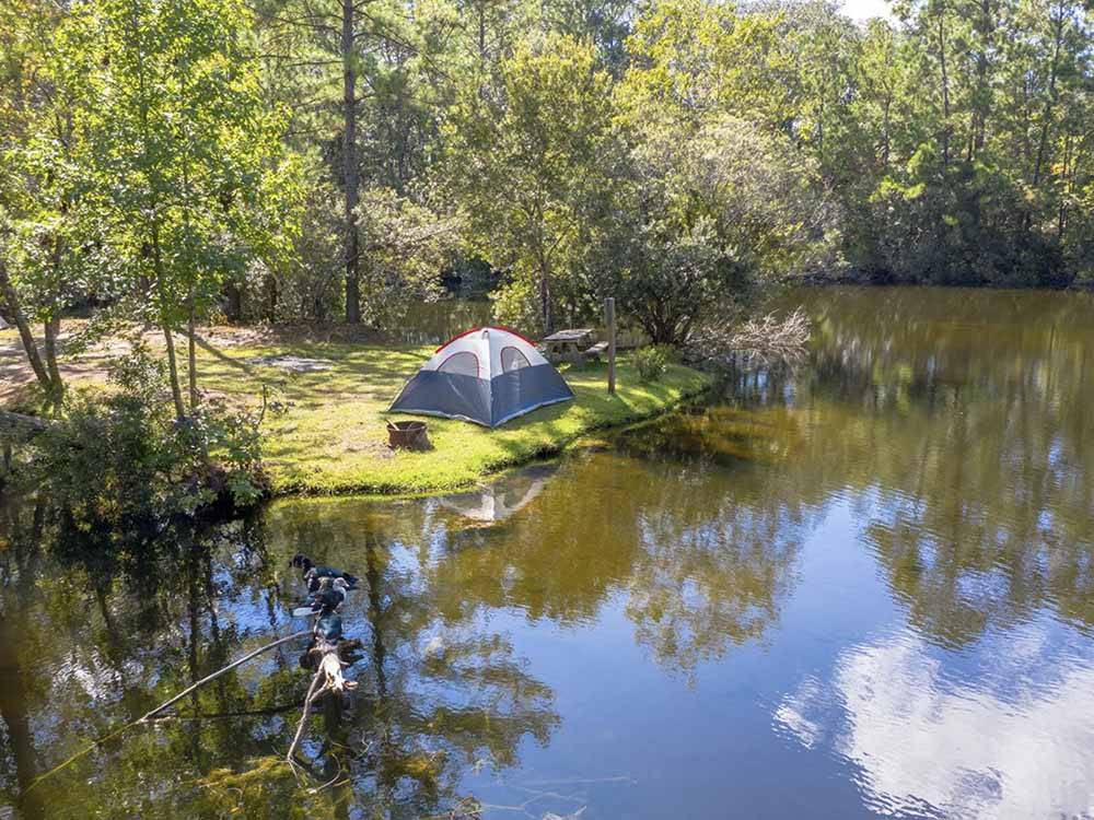A tent site by the lake at LAKE AIRE RV PARK & CAMPGROUND